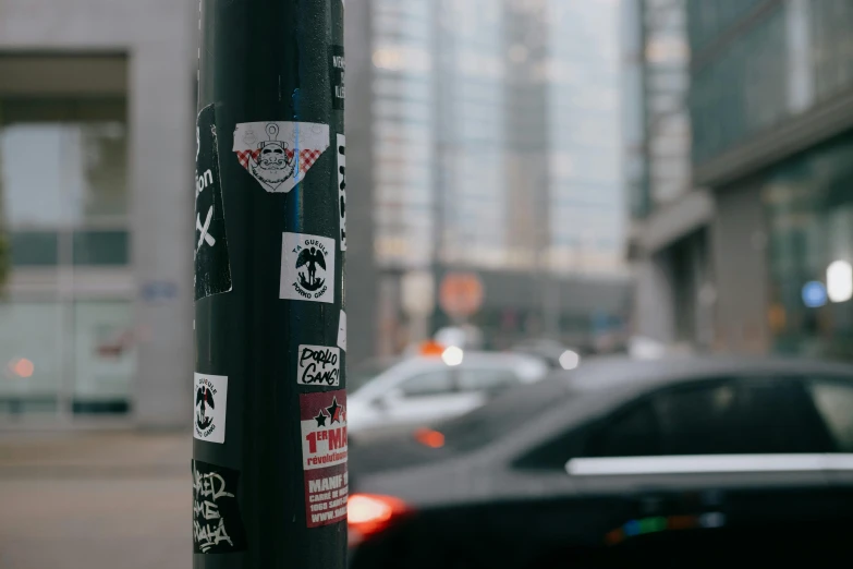 a pole with a bunch of stickers on it, pexels contest winner, street art, shepard fairey, with a sleek spoiler, square sticker, high quality upload