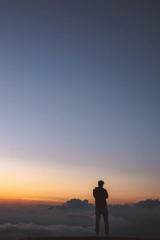 a man standing on top of a mountain at sunset, by Jacob Toorenvliet, clemens ascher, sunset panorama, dawn cgsociety, calm night. over shoulder shot