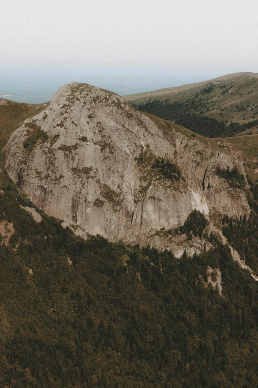 a large mountain that is covered with grass