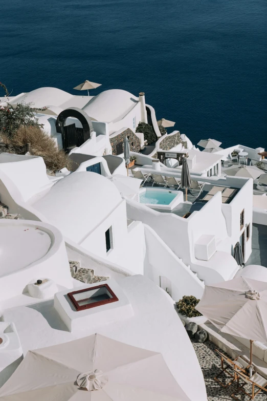 this is an overhead view of a white village with an ocean view