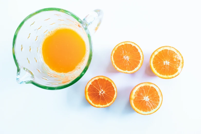 a pitcher of orange juice next to sliced oranges, by Carey Morris, pexels, 🦩🪐🐞👩🏻🦳, bird eye view, thumbnail, overexposed