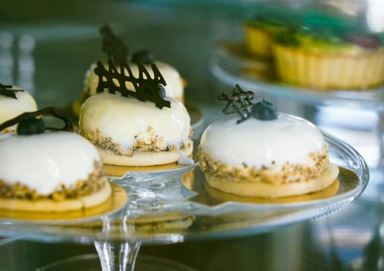 a group of pastries sitting on top of a glass plate, upclose, ivory and ebony, melbourne, gleaming white