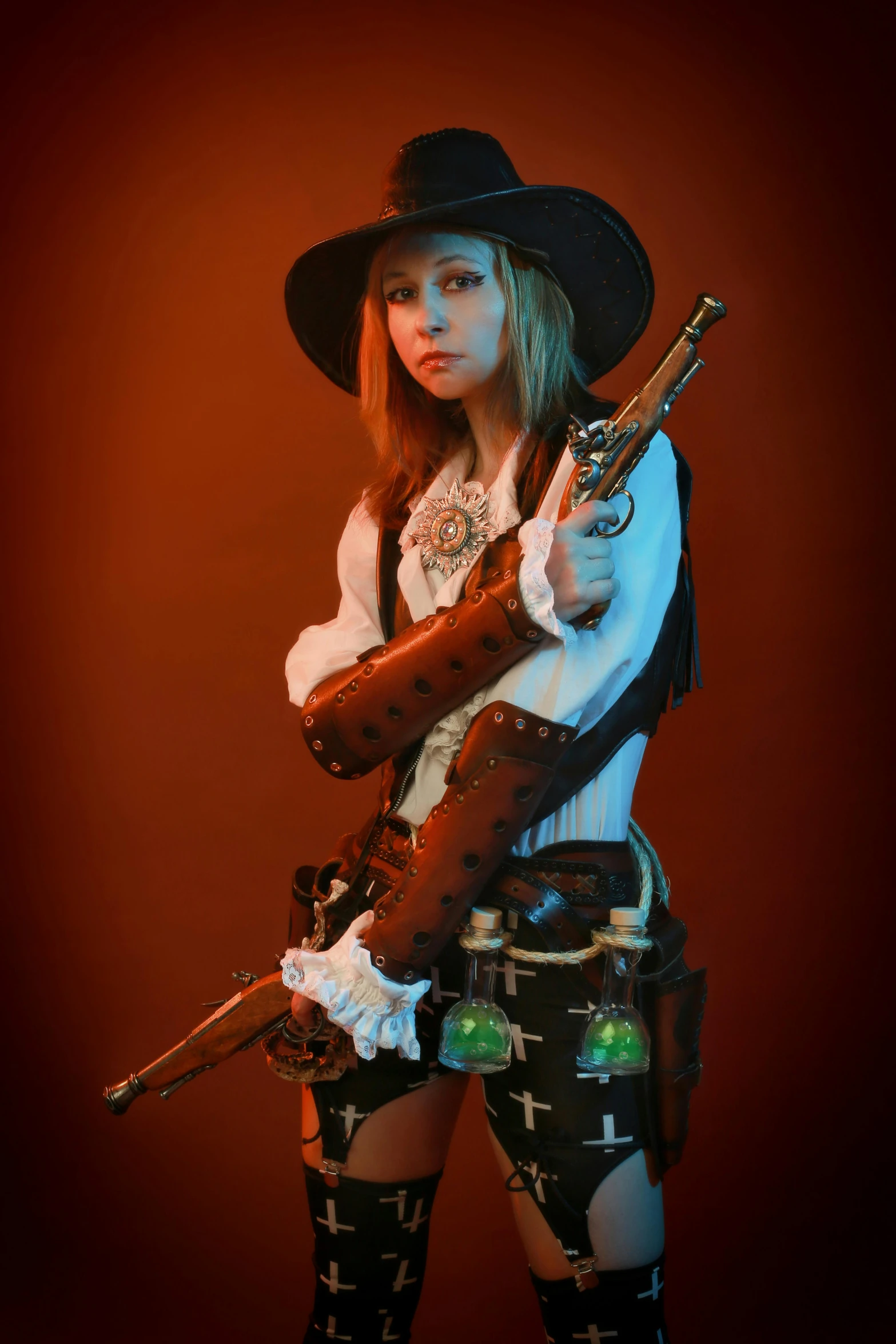 a woman in dress clothes and a hat with a gun