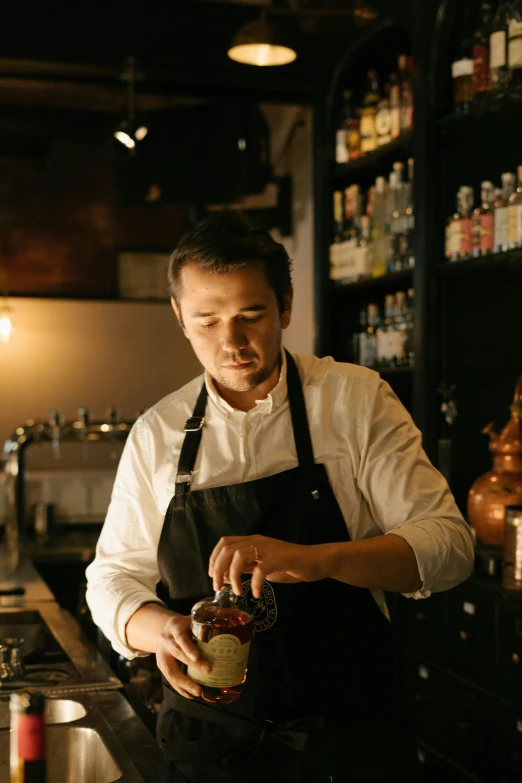 a man that is standing in front of a bar, a portrait, inspired by Yukimasa Ida, unsplash, pouring, garnish, russian and japanese mix, working