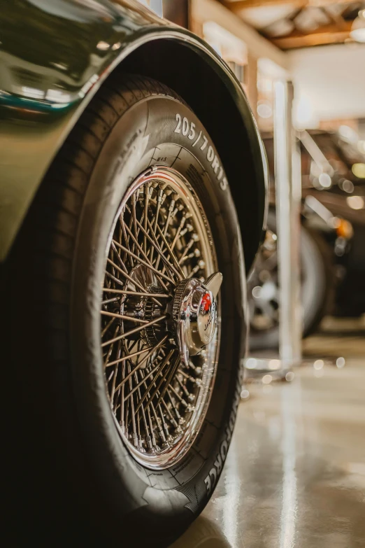 a close up of a car in a garage, by David Donaldson, pexels contest winner, photorealism, high detailed wheels, ( ( ( ( ( jaguar e - type car, 15081959 21121991 01012000 4k, inspect in inventory image