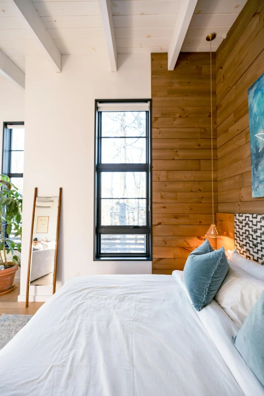 the inside of a bedroom with wood walls