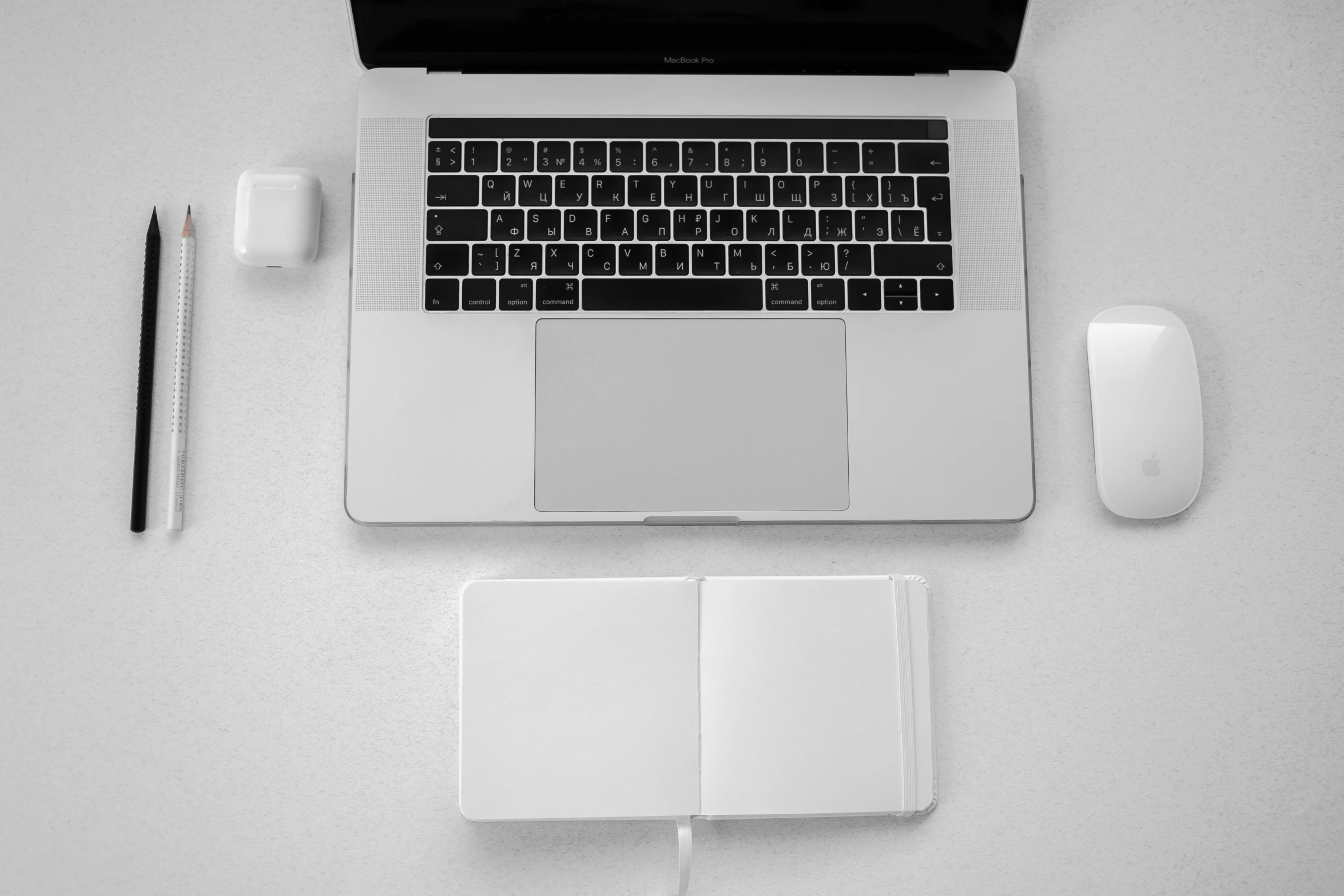 a laptop computer sitting on top of a white table, a black and white photo, by Romain brook, unsplash, knolling, apple design, white paper, creamy