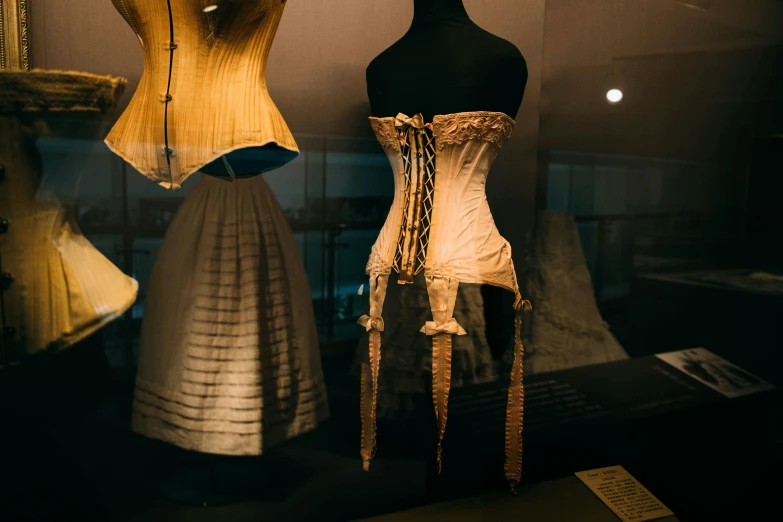 a couple of mannequins that are on display, by Elsa Bleda, trending on unsplash, art nouveau, wearing corset, mid 1 9 th century, shaped derriere, silky garment