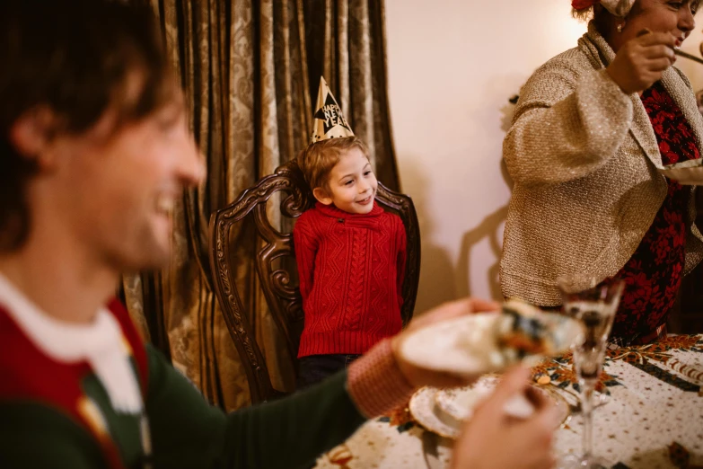 two people are sitting and eating at the table