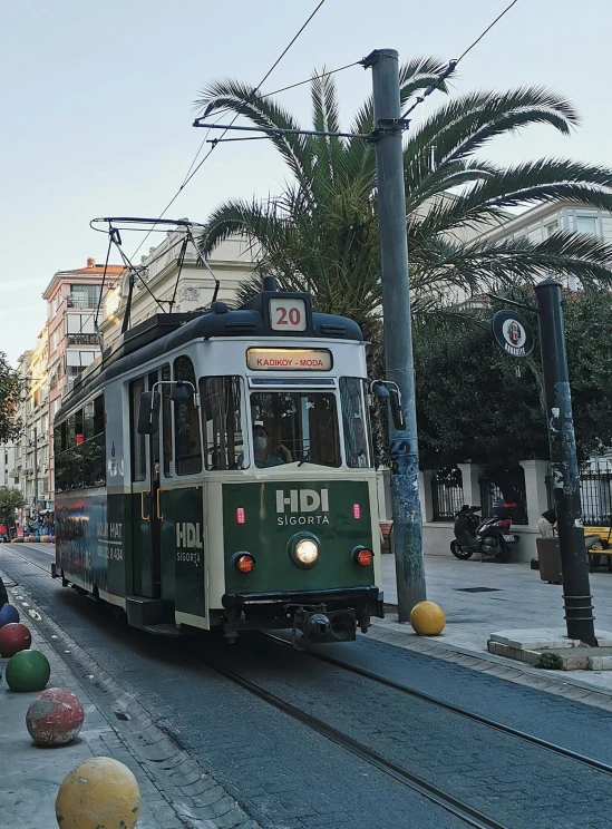 a streetcar is on the tracks near buildings