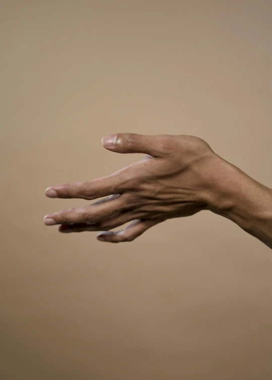 the hands are stretched out on brown background