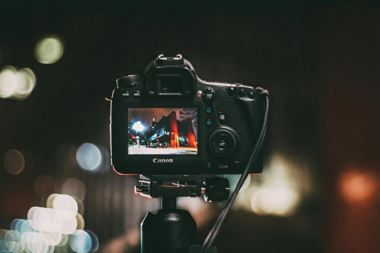 a close up of a camera on a tripod, a picture, by Carey Morris, unsplash, video art, night time photograph, dof and bokeh, youtube thumbnail, ad image