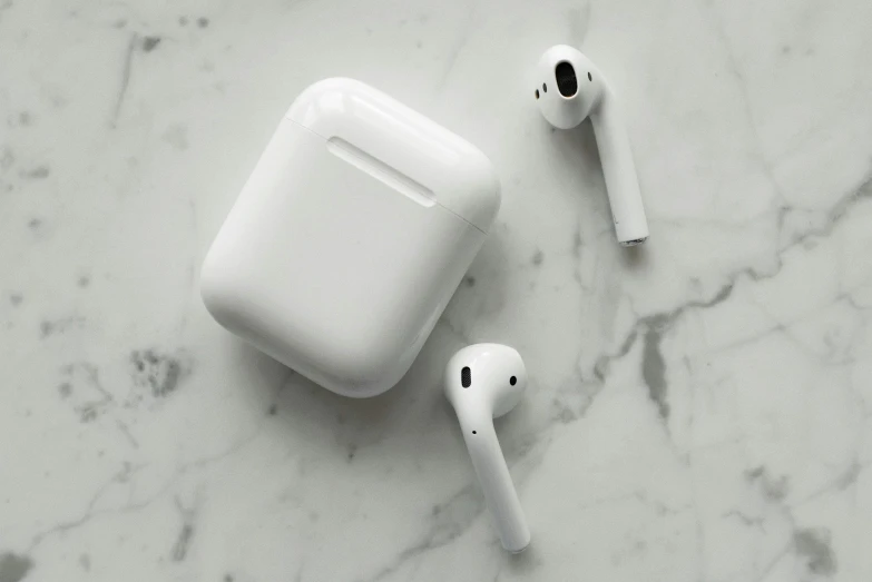 a pair of airpods sitting on top of a marble table, pexels, square, white plastic, apples, 1 2 9 7