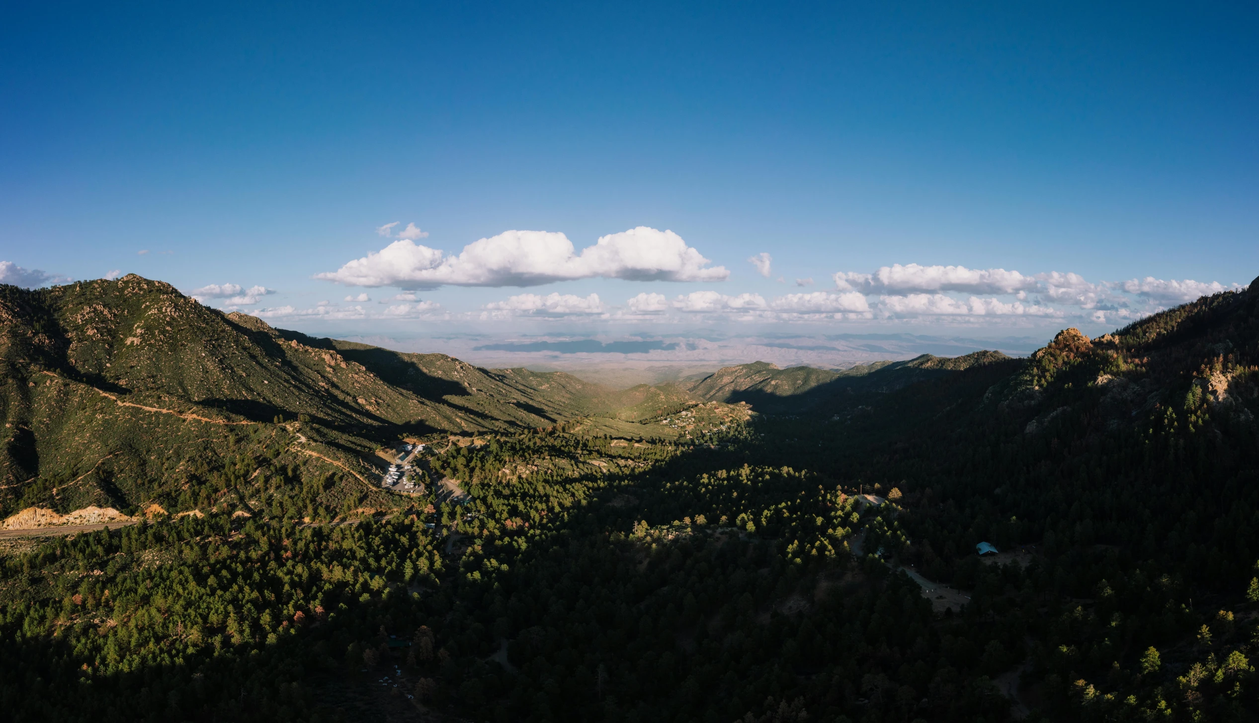 some mountains on a sunny day with a blue sky