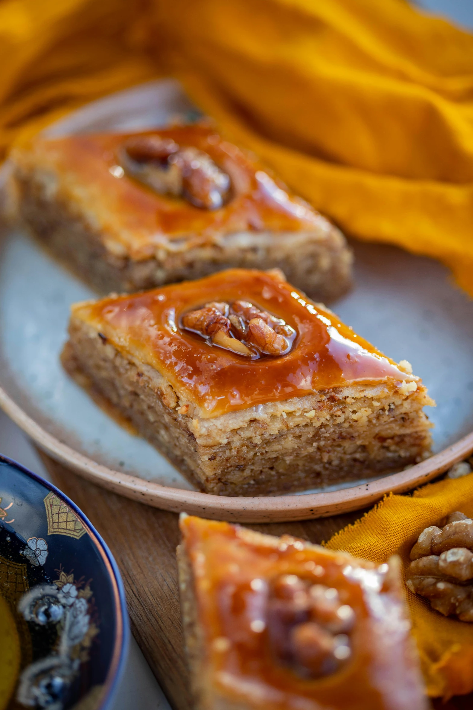 a close up of a plate of food on a table, hurufiyya, squares, cake, no cropping, amber