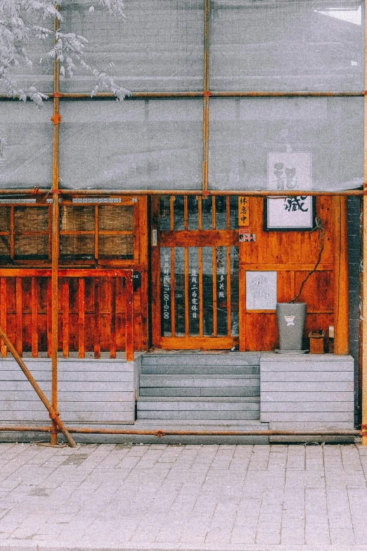 an orange building sitting under a big bridge