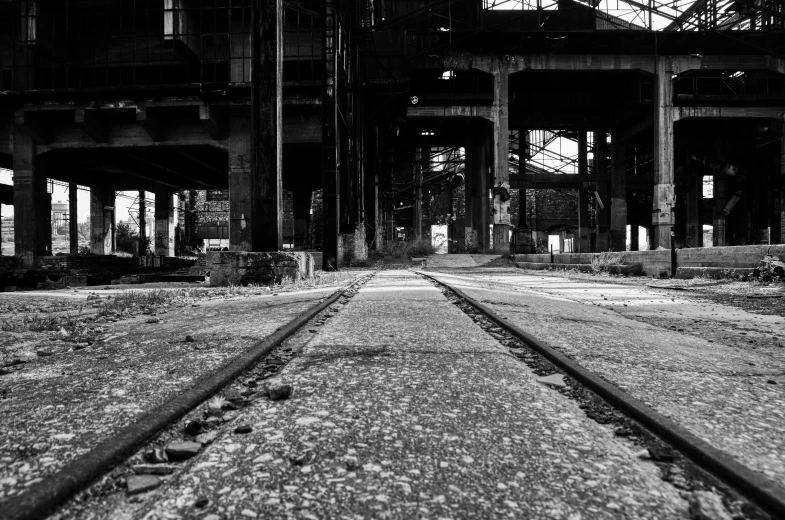 a black and white photo of a train track, abandoned warehouse, profile picture 1024px, recognizable, exposed inner structure