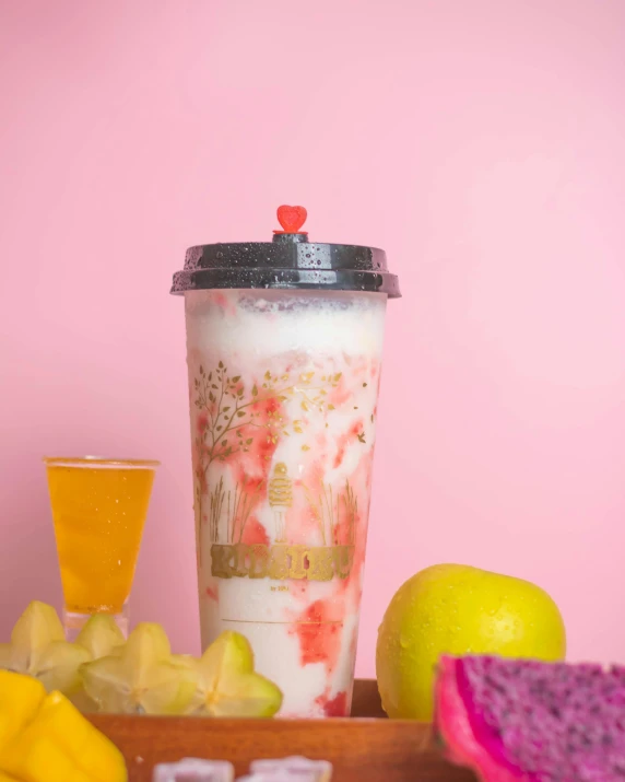 a drink sitting on top of a wooden tray next to fruit, inspired by Pearl Frush, featured on instagram, hurufiyya, colored milk tea, pink marble building, thumbnail, white holographic plastic