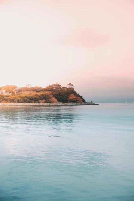 a body of water with a small island in the background