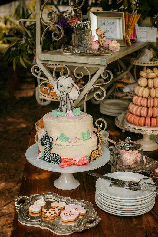 a table topped with a cake covered in frosting, lush wildlife, al fresco, high details, dessert