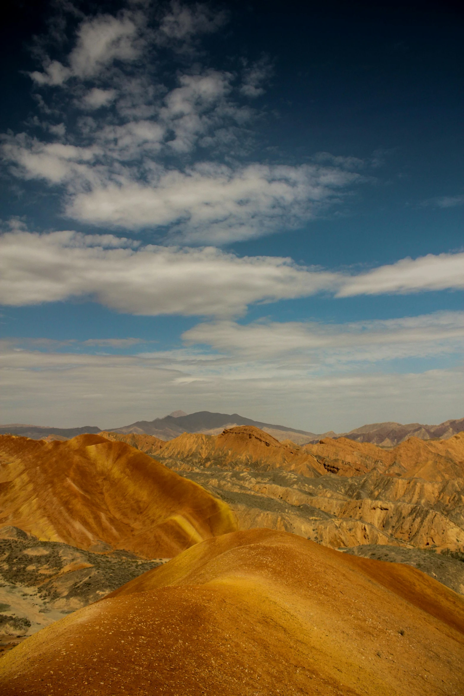 a person riding a snowboard on top of a mountain, a tilt shift photo, by Muggur, color field, death valley, yellow, /r/earthporn, landscape with red mountains