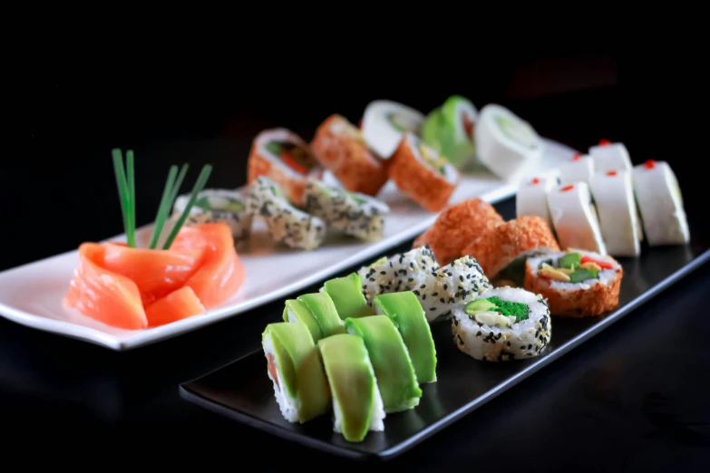 a display of different sushi on plates