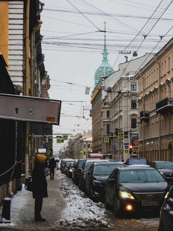 several cars parked on the street in the snow