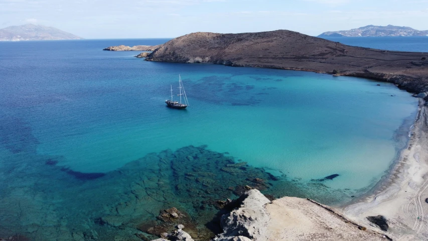 a small ship is sitting at the shore