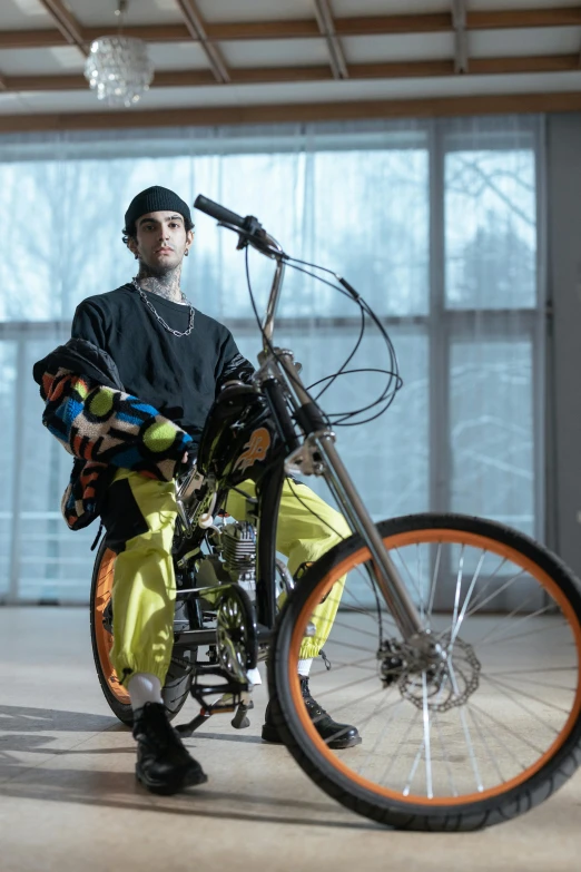 the man is sitting on his bike in a room