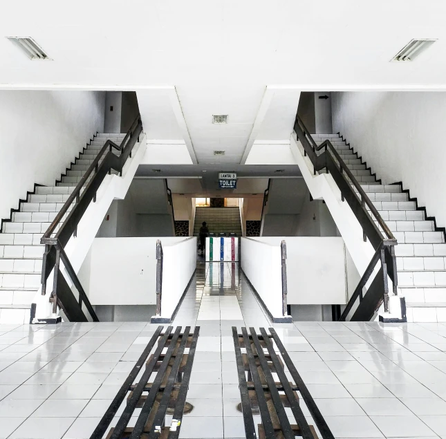 a couple of benches sitting on top of a tiled floor, an album cover, inspired by Thomas Struth, unsplash, hyperrealism, escalators, indonesia, ignant, abandoned mall in the 1 9 8 0 s