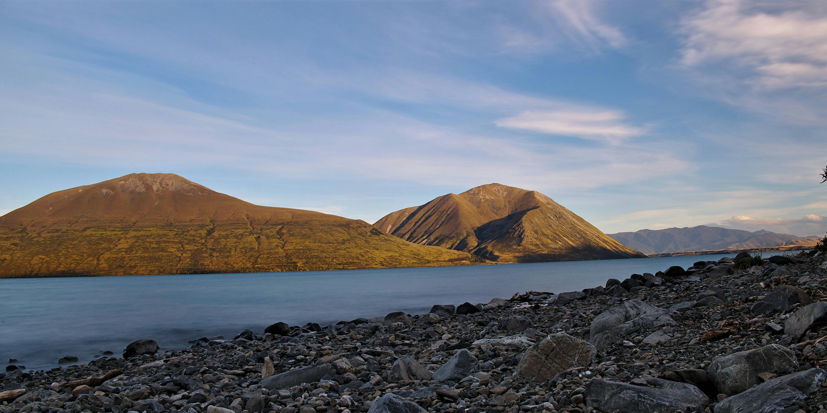 view of mountains and a lake from the shore