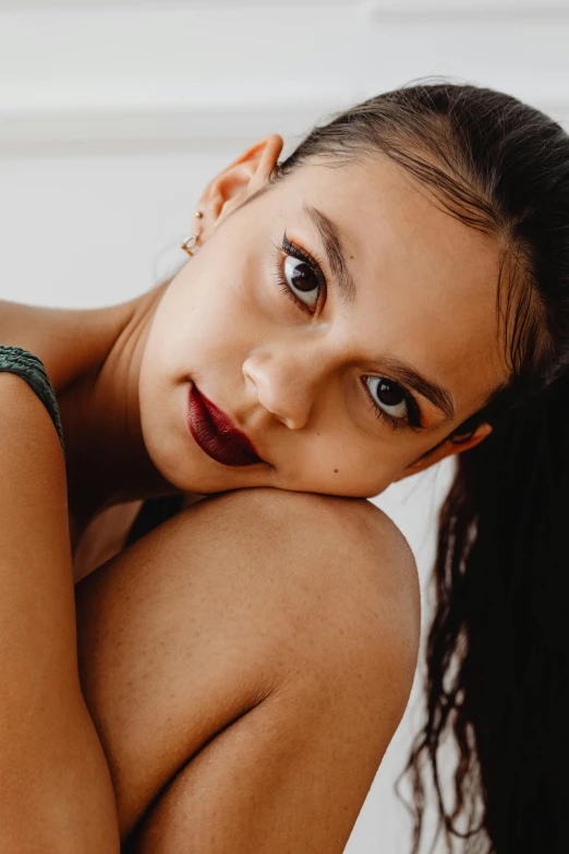 a beautiful young woman sitting on top of a bed, trending on pexels, half body portrait of juliana, arm around her neck, dark lipstick, deep tan skin
