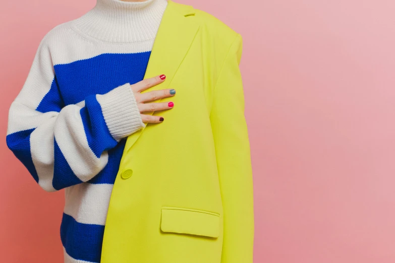 a woman holding a yellow jacket over her shoulder, trending on pexels, de stijl, pink and blue colour, painted nails, subject detail: wearing a suit, chartreuse color scheme