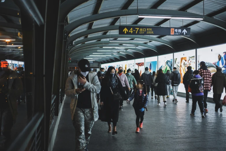 a group of people walking through a train station, tunnels, portrait featured on unsplash, monorail station, instagram post