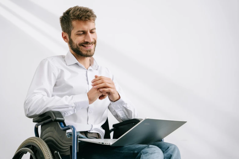 a man in a wheelchair using a laptop, trending on pexels, hurufiyya, proud looking away, avatar image, professional profile picture, lachlan bailey