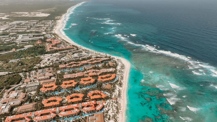 a large body of water next to a beach, by Daniel Lieske, pexels contest winner, orange and turquoise, birdeye, resort, atlantis city