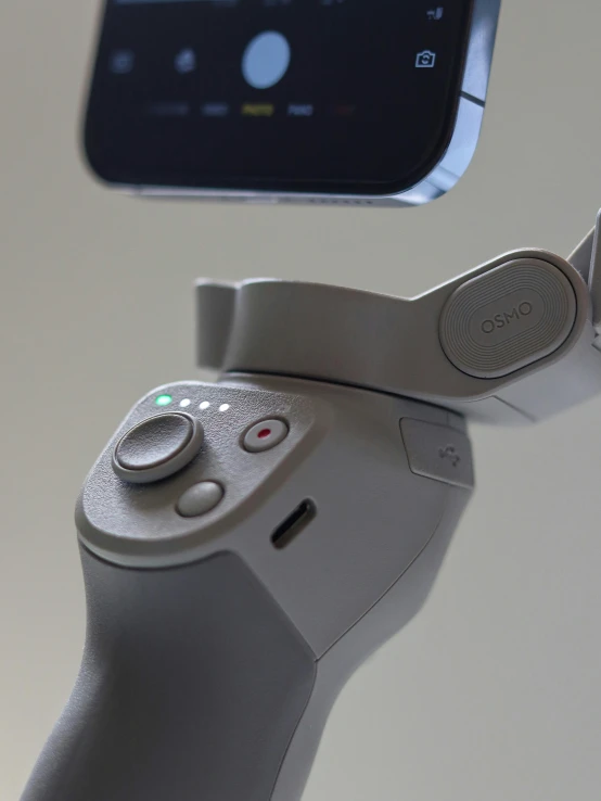 a close up of a remote control with a cell phone in the background, robotic limbs, hasselblad quality, gray, thumbnail