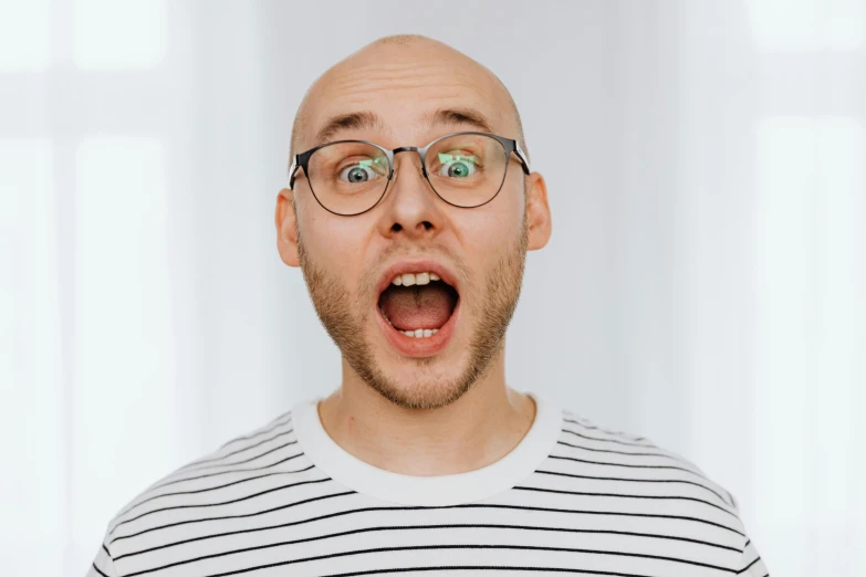 a man with a surprised look on his face, inspired by Leo Leuppi, pexels contest winner, bald patch, avatar image, nerdy appearance, wide mouth