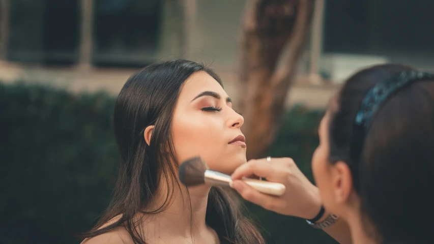 a woman putting makeup on another woman's face, pexels contest winner, slightly tanned, avatar image, brunette woman, subtle shadows