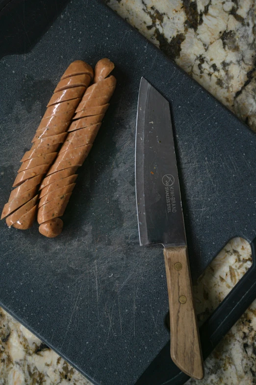 a couple of hot dogs sitting on top of a cutting board, a still life, unsplash, renaissance, tactical knife, spiral, hand carved brown resin, unedited