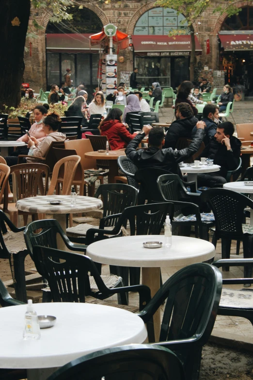 several people in the distance are sitting at tables