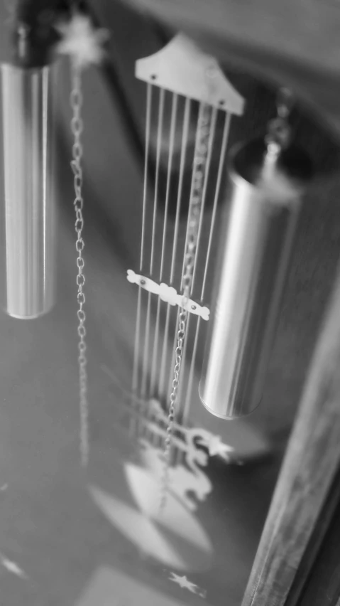 a black and white photo of a fire hydrant, an album cover, inspired by Cerith Wyn Evans, purism, with an harp, closeup - view, wind chimes, featuring rhodium wires