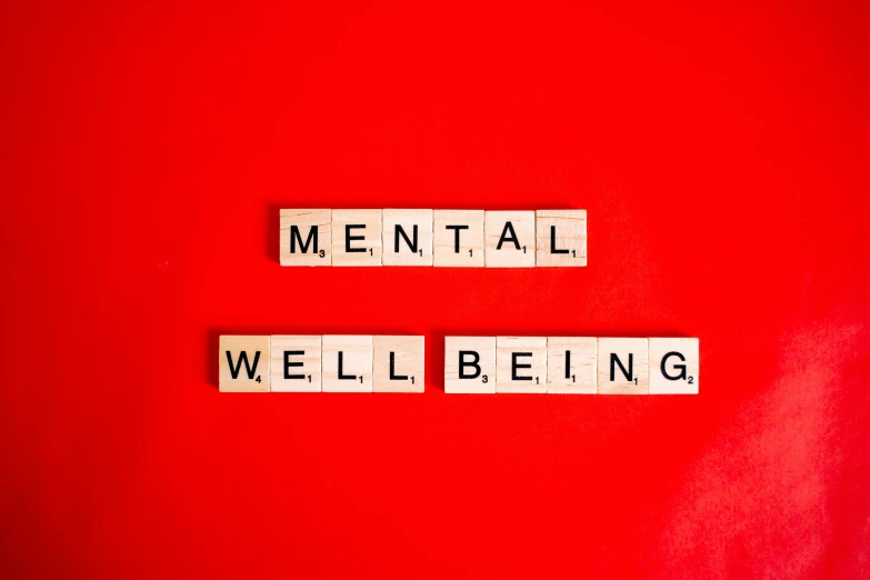 the words mental well being spelled in scrabbles on a red background, by Emma Andijewska, trending on pexels, aestheticism, on a gray background, 🦩🪐🐞👩🏻🦳, ptsd, seen from below