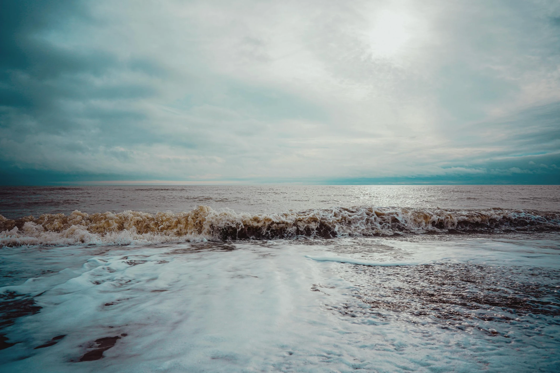 there is a beach with waves coming up on it