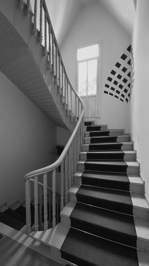 black and white image of stair going down the side