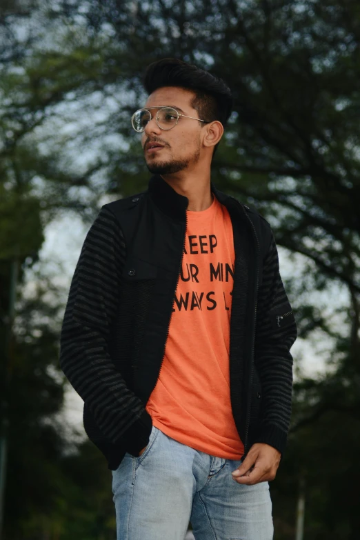 a man in a baseball hat wearing an orange shirt with the slogan keep our minds