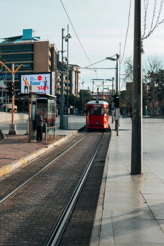 there is a red train that is on the tracks