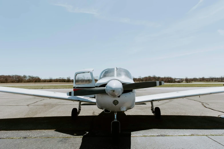 a small airplane sitting on top of an airport tarmac, pexels contest winner, baroque, 3/4 front view, silver wings, full front view, bottom angle