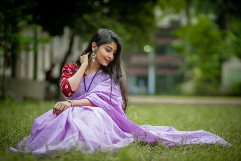 a young woman dressed in a purple and red dress and pink clutch bag