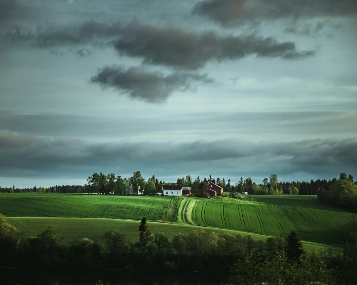 a red barn sitting on top of a lush green field, a matte painting, by Anato Finnstark, pexels contest winner, overcast dusk, swedish houses, teal landscape, on a green hill between trees